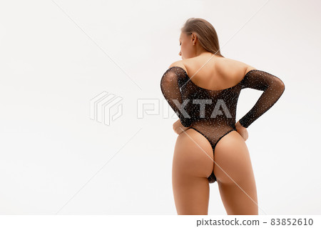 Seductive woman wearing black bodysuit and high heels 83852610