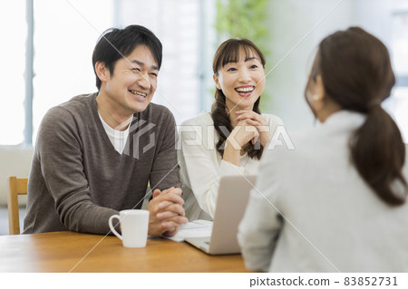 A couple and a business woman having a business talk A couple and a business woman having a business talk 83852731