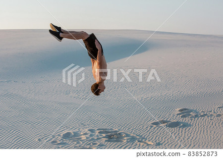 Man study parkour on their own. Acrobatics in the sand 83852873