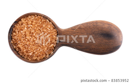 Brown sugar in wooden spoon, isolated on white background. Heap of cane sugar crystals. Top view. Brown sugar in wooden spoon, isolated on white background. Heap of cane sugar crystals. Top view. 83853952