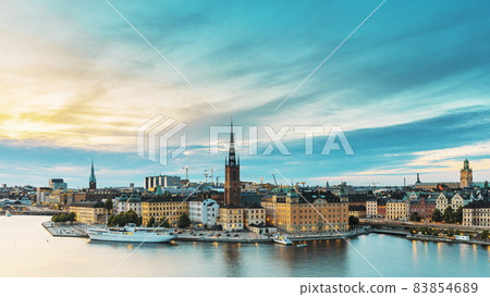 Stockholm, Sweden. Scenic View Of Stockholm Skyline At Summer Evening. Famous Popular Destination Scenic Place In Dusk Lights. Riddarholm Church In Day To Night Transition Time Lapse Stockholm, Sweden. Scenic View Of Stockholm Skyline At Summer Evening. Famous Popular Destination Scenic Place In Dusk Lights. Riddarholm Church In Day To Night Transition Time Lapse 83854689