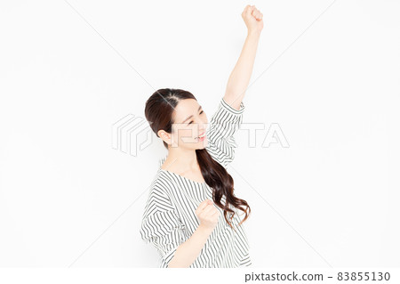 A woman in casual clothes doing a guts pose A woman in casual clothes doing a guts pose 83855130