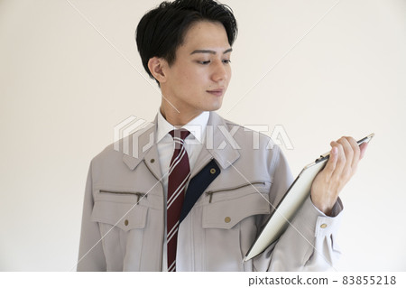 Blue collar man with binder Blue collar man with binder 83855218
