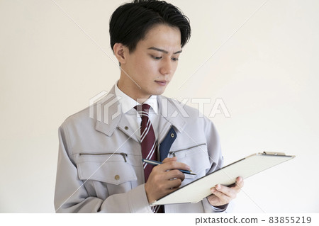 Blue collar man with binder Blue collar man with binder 83855219