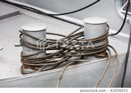 Knecht on bollard of sea commercial port Knecht on bollard of sea commercial port 83856053