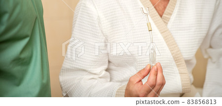 Young caucasian man receiving nasal inhalation Maholda with essential oil in the nose at a hospital. 83856813