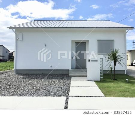 Simple modern one-story house with white plaster walls Simple modern one-story house with white plaster walls 83857435