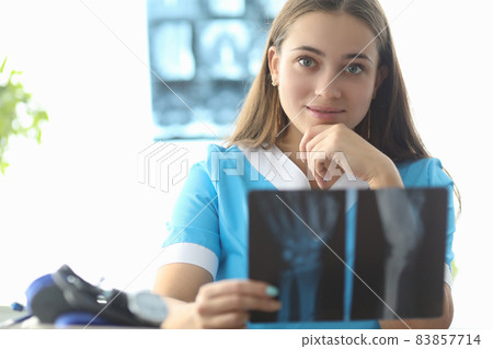Doctor traumatologist holding xray of hand in clinic 83857714