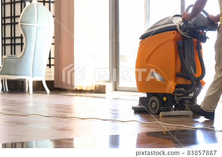 Cleaner washing floor in hotel using special machine closeup Cleaner washing floor in hotel using special machine closeup 83857887