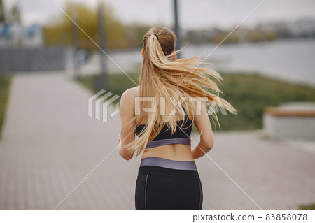 Sports girl training in a summer park 83858078