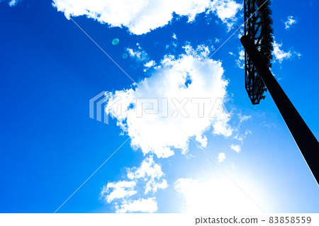 Baseball field, blue sky and lighting 83858559