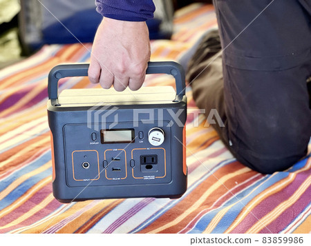Male hand with portable power supply Male hand with portable power supply 83859986