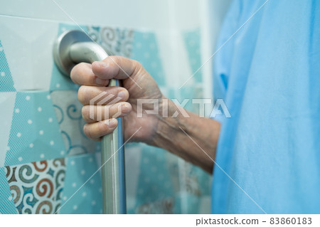 Asian senior or elderly old lady woman patient use toilet bathroom handle security in nursing hospital ward, healthy strong medical concept. 83860183