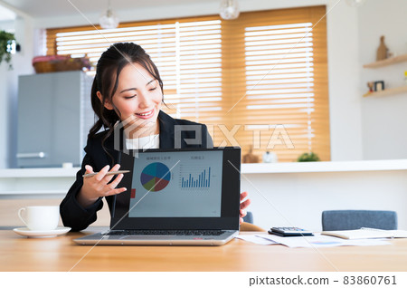 Sales woman presenting on a computer Sales woman presenting on a computer 83860761