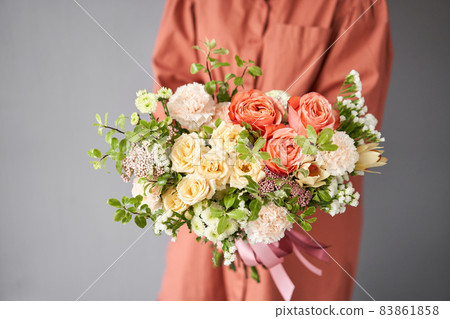 Beautiful bouquet of mixed flowers in woman hand. Floral shop concept . Beautiful fresh cut bouquet. Flowers delivery 83861858