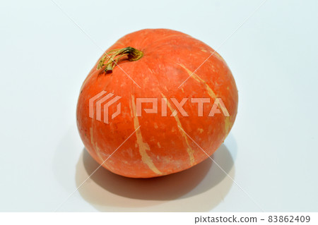Ripe pumpkin lies on a white table. Ripe pumpkin lies on a white table. 83862409