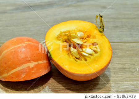 Two halves of a ripe striped pumpkin. Two halves of a ripe striped pumpkin. 83862439