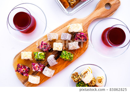 Traditional tea with lokum and muska, Turkish delight. Traditional tea with lokum and muska, Turkish delight. 83862825