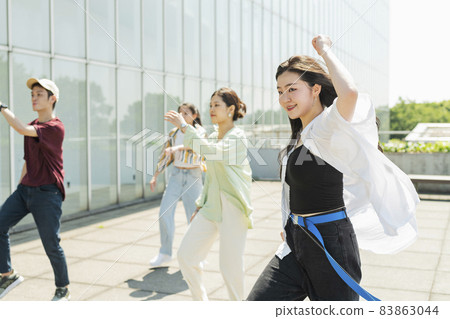 A woman dancing with her friends A woman dancing with her friends 83863044