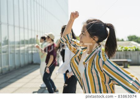 A woman dancing with her friends A woman dancing with her friends 83863074