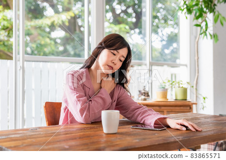 A sick woman wearing a loungewear in a bright room 83865571