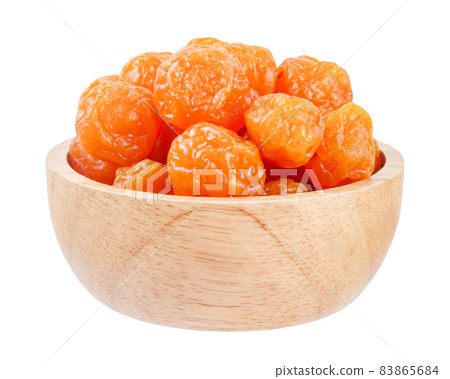 Dried prunes fruits (Preserved fruits Chinese plum) in wooden bowl isolated on white background. 83865684