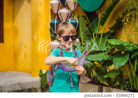 Boy traveler on background of Hoi An ancient town, Vietnam. Vietnam opens to tourists again after quarantine Coronovirus COVID 19 83866271