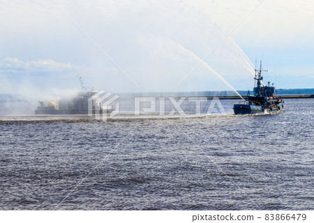 Extinguishing a burning ship during naval exercises Extinguishing a burning ship during naval exercises 83866479