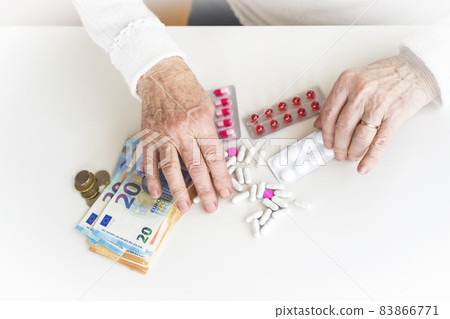 An older retired woman is counting money and saving it for medicines. An older retired woman is counting money and saving it for medicines. 83866771