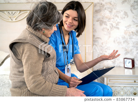 Young nurse is caring for an elderly 80 year-old woman at home. 83867734