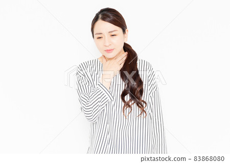 A woman in casual clothes who has a cold and a sore throat A woman in casual clothes who has a cold and a sore throat 83868080