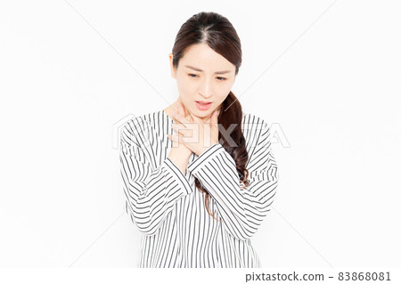 A woman in casual clothes who has a cold and a sore throat A woman in casual clothes who has a cold and a sore throat 83868081