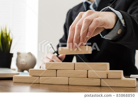 front view businessman with wooden building blocks. High quality beautiful photo concept 83868850