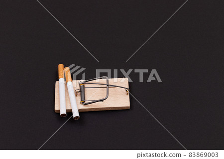 Tobacco Addiction - Cigarettes in Wooden Mousetrap Tobacco Addiction - Cigarettes in Wooden Mousetrap 83869003