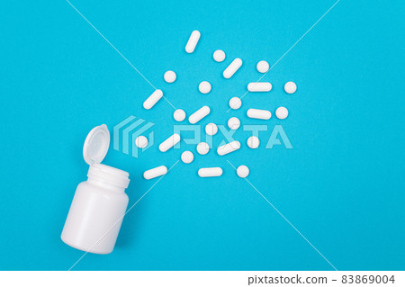 Pharmaceutical Industry and Medicinal Products - White Pills on Blue Table Pharmaceutical Industry and Medicinal Products - White Pills on Blue Table 83869004