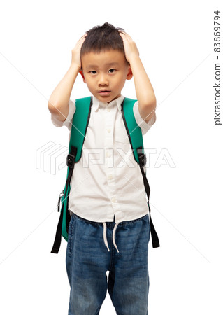 Kid with school backpack standing tired and bored with hands on head Kid with school backpack standing tired and bored with hands on head 83869794