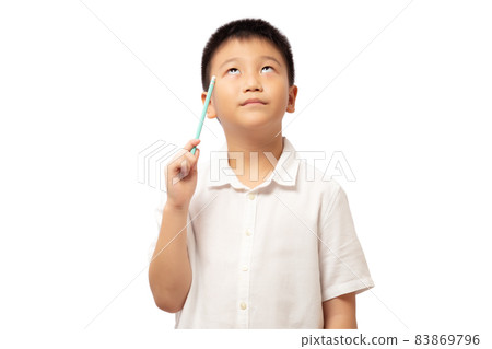 Kid thinking and looking up with pencil in hand 83869796