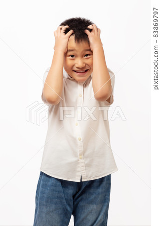 Kid frustrated while thinking with hands on head 83869797