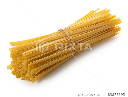 raw spaghetti closeup on white isolated background raw spaghetti closeup on white isolated background 83872695