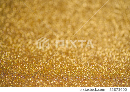 Glitter gold background. Texture foil and confetti bokeh, light of golden dust. Festive party Christmas and new year's eve background. Glitter gold background. Texture foil and confetti bokeh, light of golden dust. Festive party Christmas and new year's eve background. 83873600