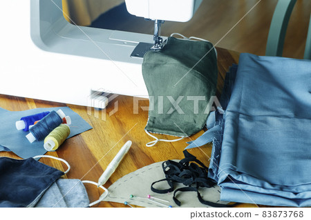 Face mask sewing DIY and making homemade covid mask concept. Sewing an individual antibacterial face mask from colored fabric at home Face mask sewing DIY and making homemade covid mask concept. Sewing an individual antibacterial face mask from colored fabric at home 83873768