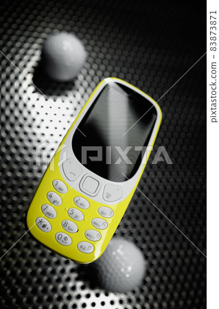 Shockproof phone on metal surface with golf balls 83873871
