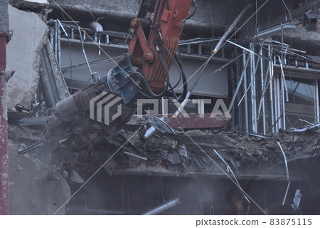 Dismantling site of distribution warehouse Demolition with large heavy machinery 83875115
