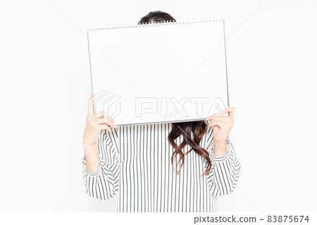Casually dressed woman with a large sketchbook 83875674