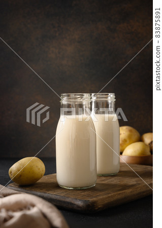 Vegan potato milk in bottles, plant based milk replacer. Vegan potato milk in bottles, plant based milk replacer. 83875891