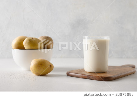 Vegan potato milk in glass, plant based milk replacer. Vegan potato milk in glass, plant based milk replacer. 83875893
