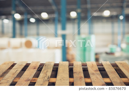 blur raw material warehouse storage zone with wooden pallet floor foreground for advertising montage background blur raw material warehouse storage zone with wooden pallet floor foreground for advertising montage background 83876670
