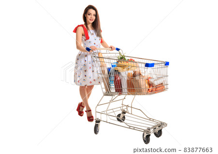 Young woman with full shopping cart on white background 83877663