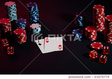 Casino chips and cards on black table surface. Gambling, fortune, game and entertainment concept - close up Casino chips and cards on black table surface. Gambling, fortune, game and entertainment concept - close up 83878774