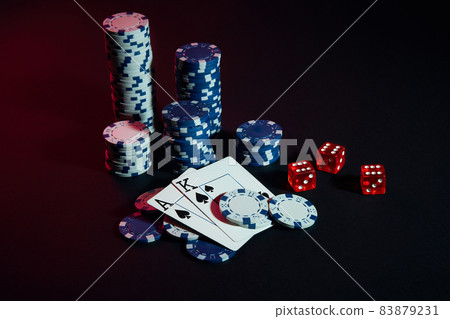 Stack of chips and two cards on dark background - poker game concept 83879231
